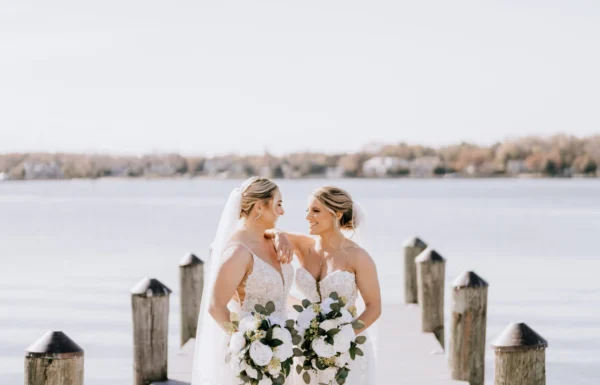 A Waterfront Wedding Featuring The Couple’s Dog & Pride Flags at the Ceremony
