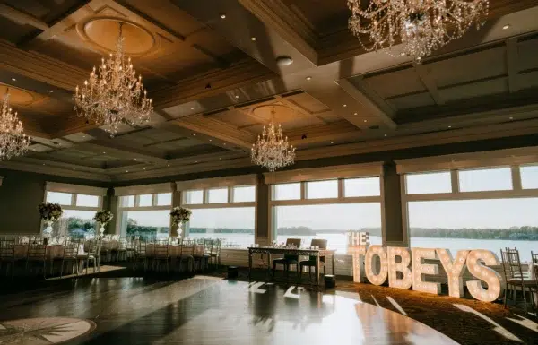 A Waterfront Wedding Featuring The Couple’s Dog & Pride Flags at the Ceremony